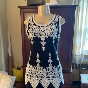 Elegant women’s top. Scalloped and embroidered details.  Black white. Stunning.